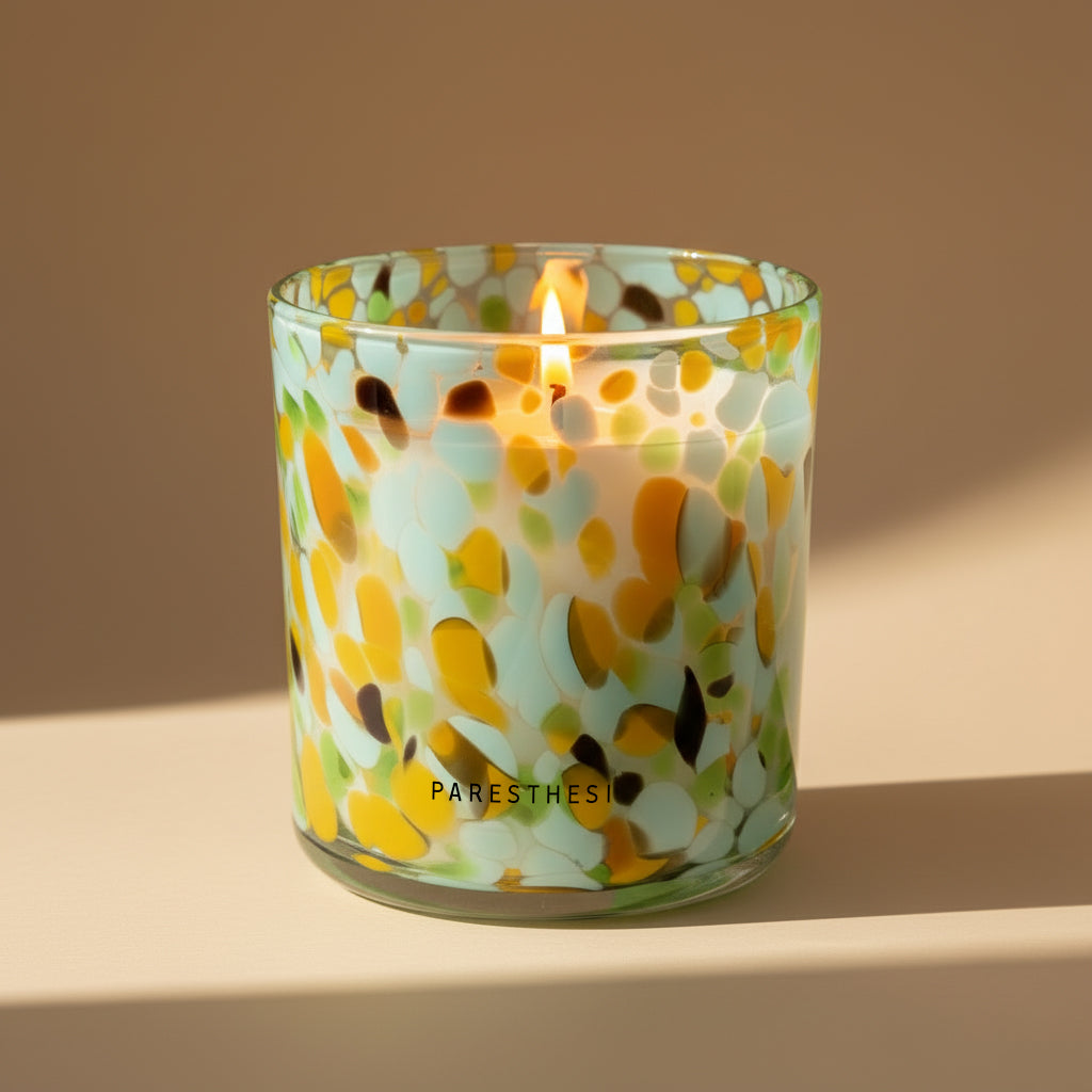Candle in a glass jar with floral pattern on a beige background