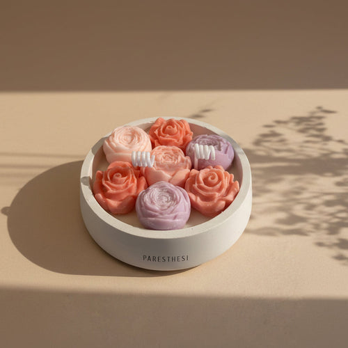 Bloom Harmony Candle 200ml. Flower in a white porcelain vessel in a beige background