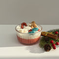 Decorative candle with a Gingerbread figure and festive elements on a white background