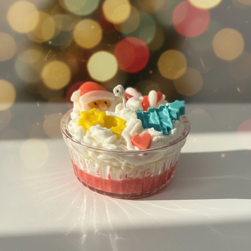 Decorative candle with a Santa figure and festive elements