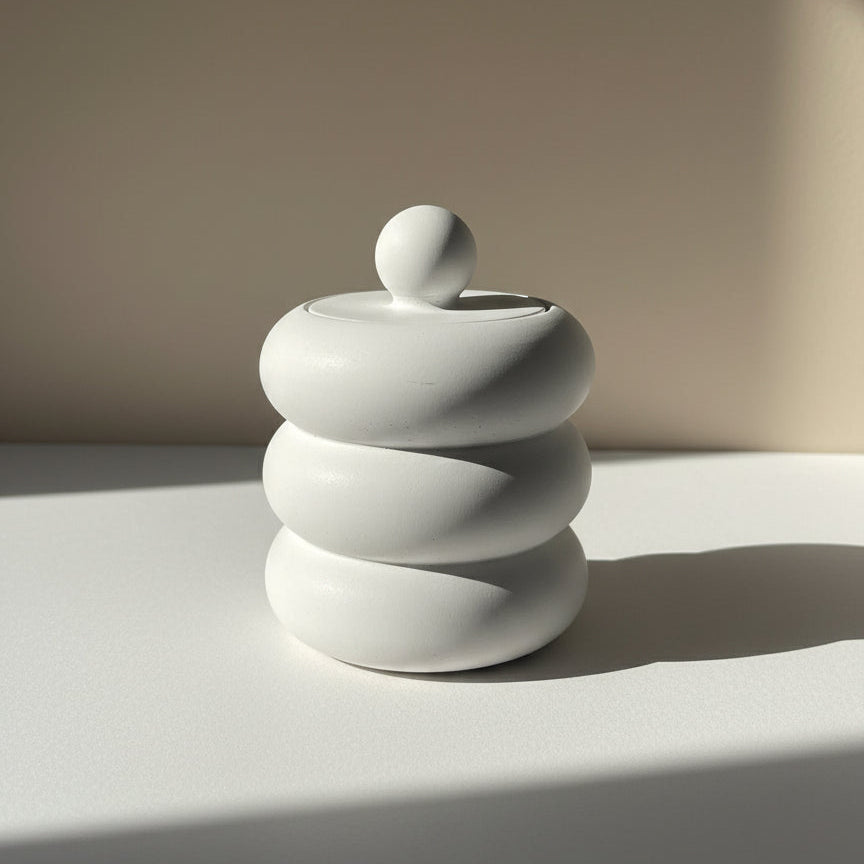 White Porcelain Candle Jar with a lid on a light surface with a neutral background