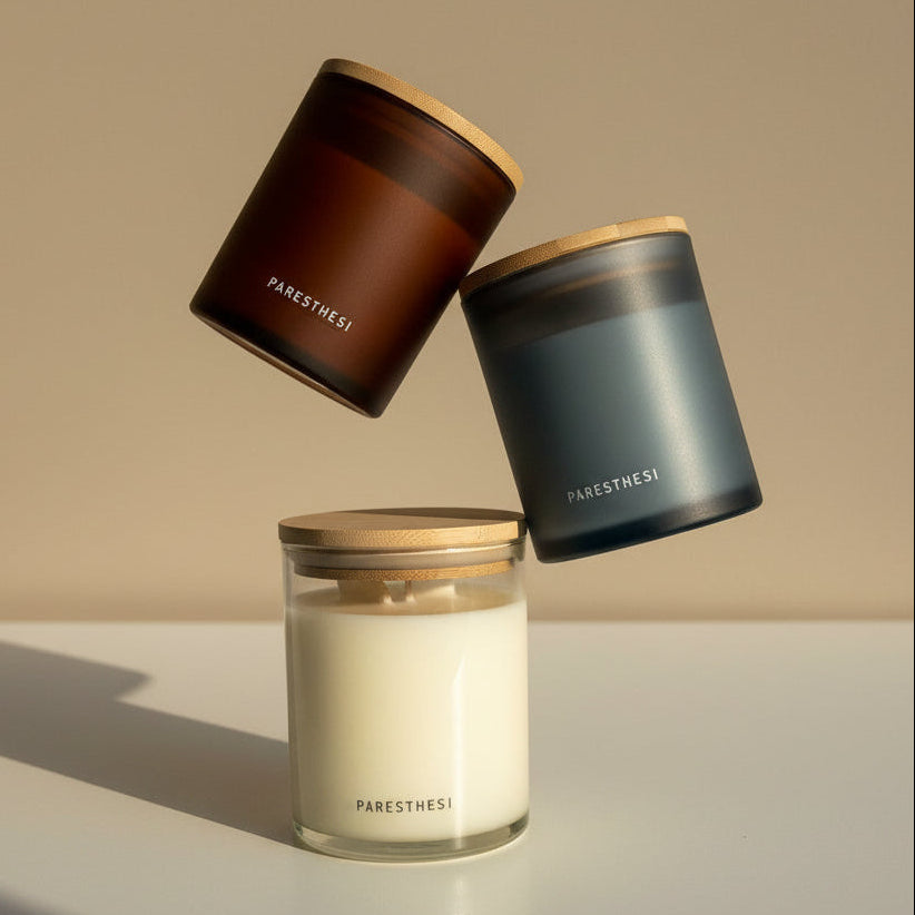 Three candles from the brand 'PARESTHESi' on a neutral background