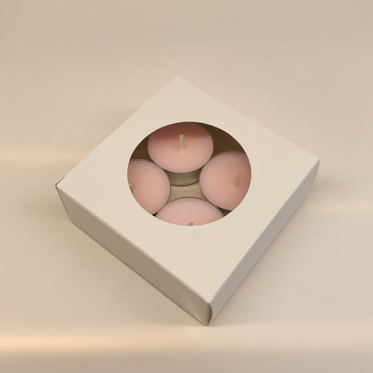 Box of pink candles on a light beige background