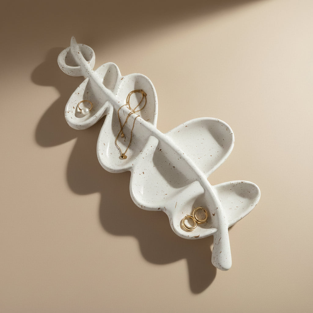 White porcelain jewelry holder with gold earrings on a beige background