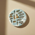 Porcelain jewelry tray with a marbled design on a beige background
