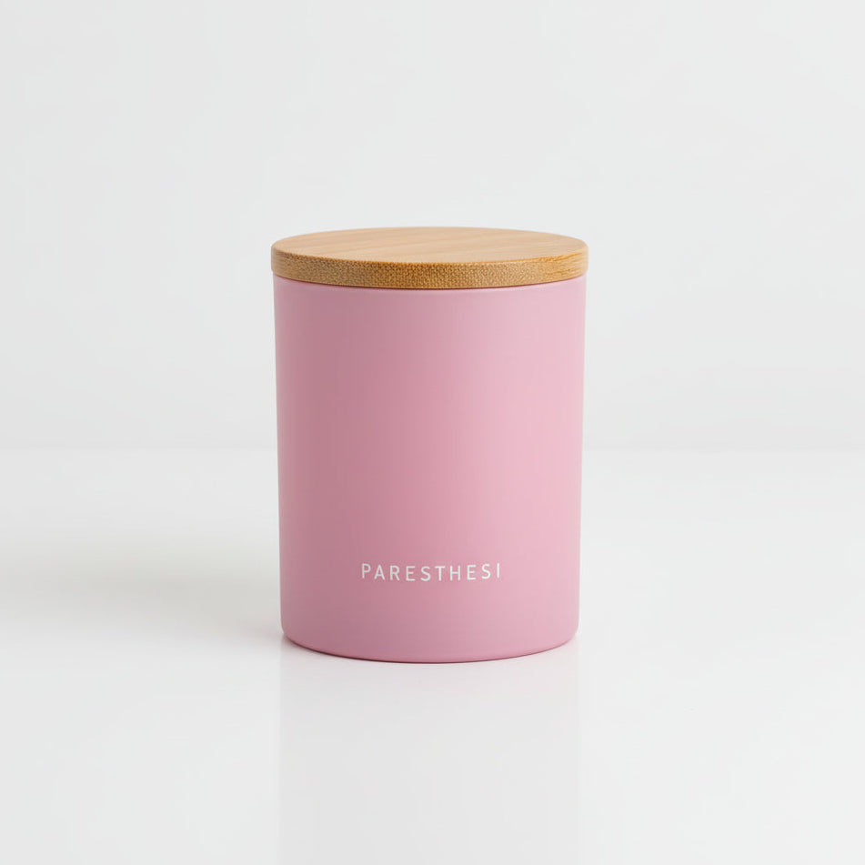 Pink container with a wooden lid on a white background