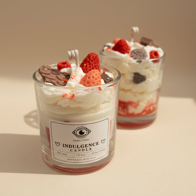 Decorative candle with strawberry and chocolate elements on a white background