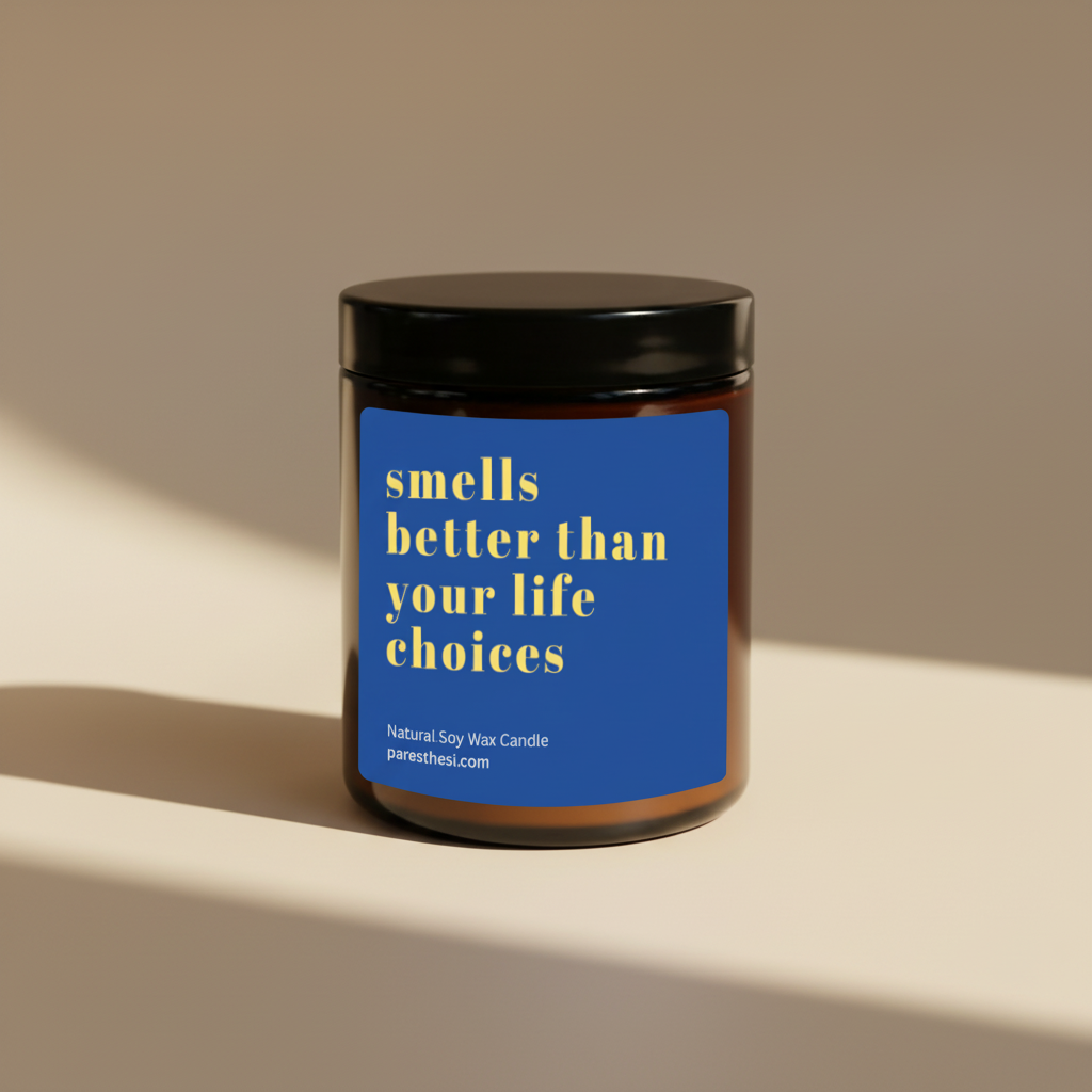 A soy wax candle in an amber glass jar with a black lid and a blue label that reads 'smells better than your life choices' in yellow text, shown on a plain beige background.