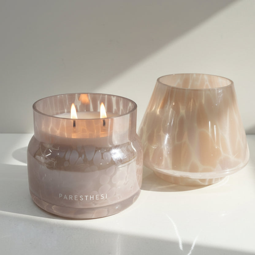 Lamp Candle in pink vessel on a white surface with 'PARESTHESI' branding.