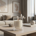 Candle in a glass holder on a coffee table in a living room setting