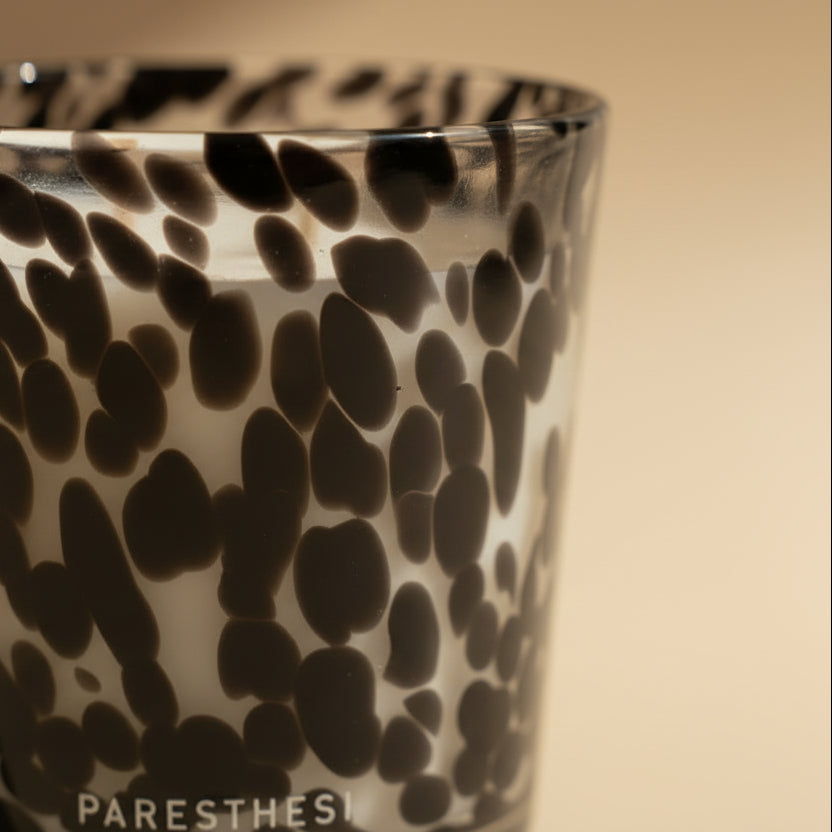 Black and white patterned glass candle holder on a light beige background