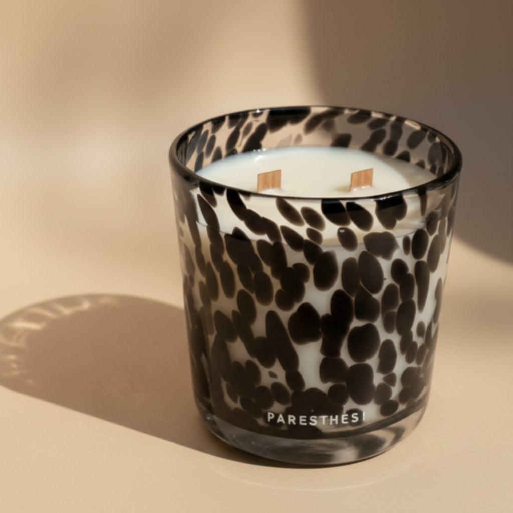 Black and white patterned glass candle holder on a light beige background