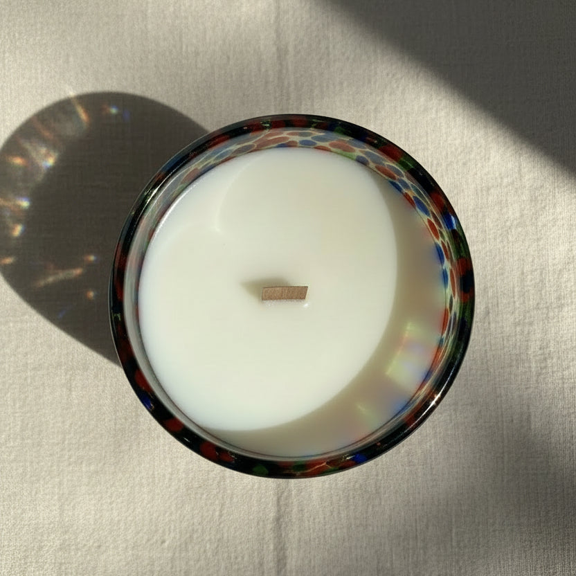 Colorful glass bowl on a reflective surface