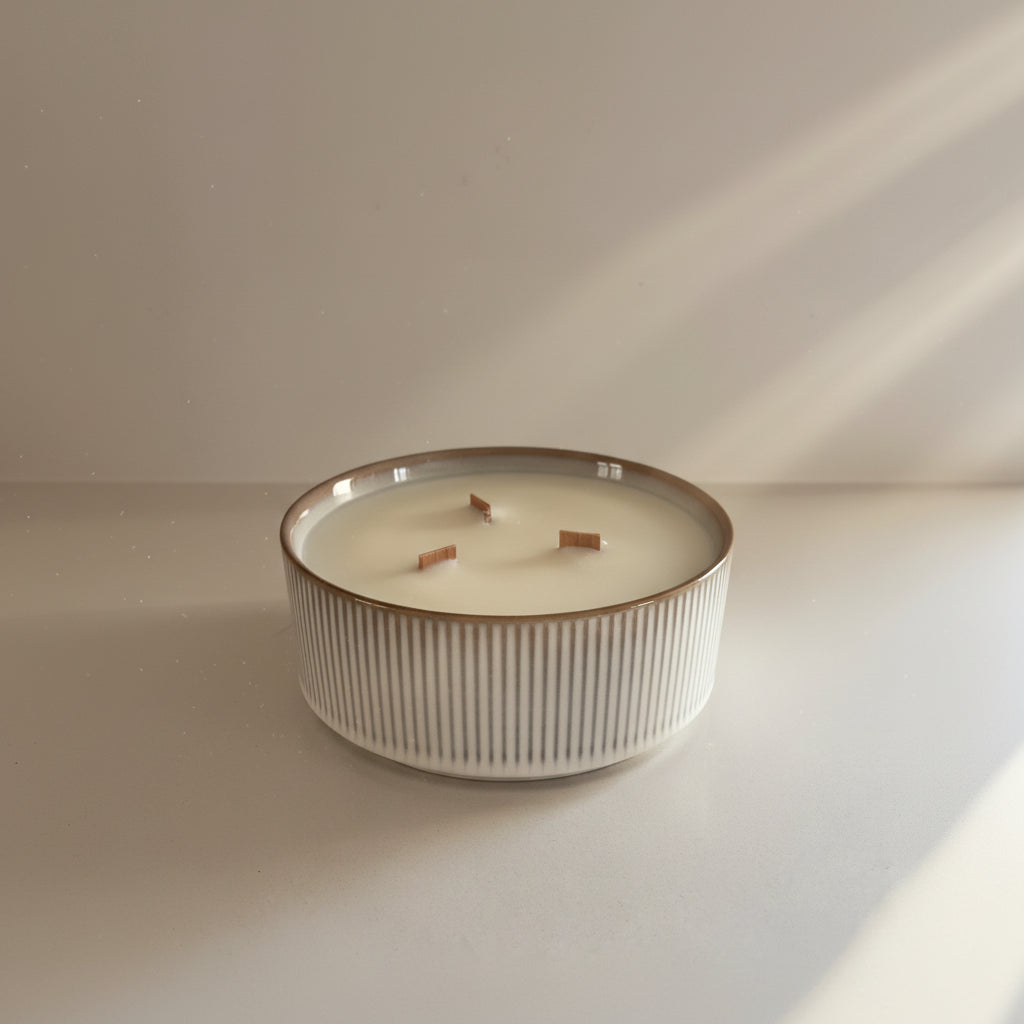 Ceramic candle with a striped design on a plain background